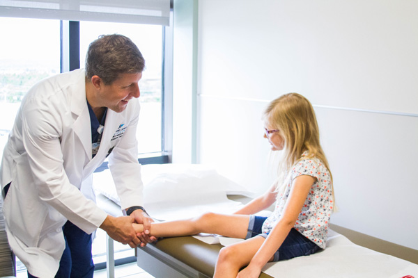 Doctor examining child's foot